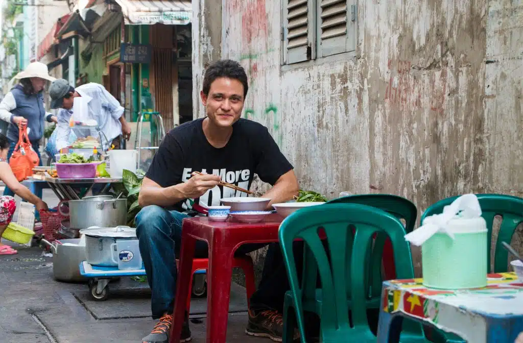 Mark Wiens sitting at a table.