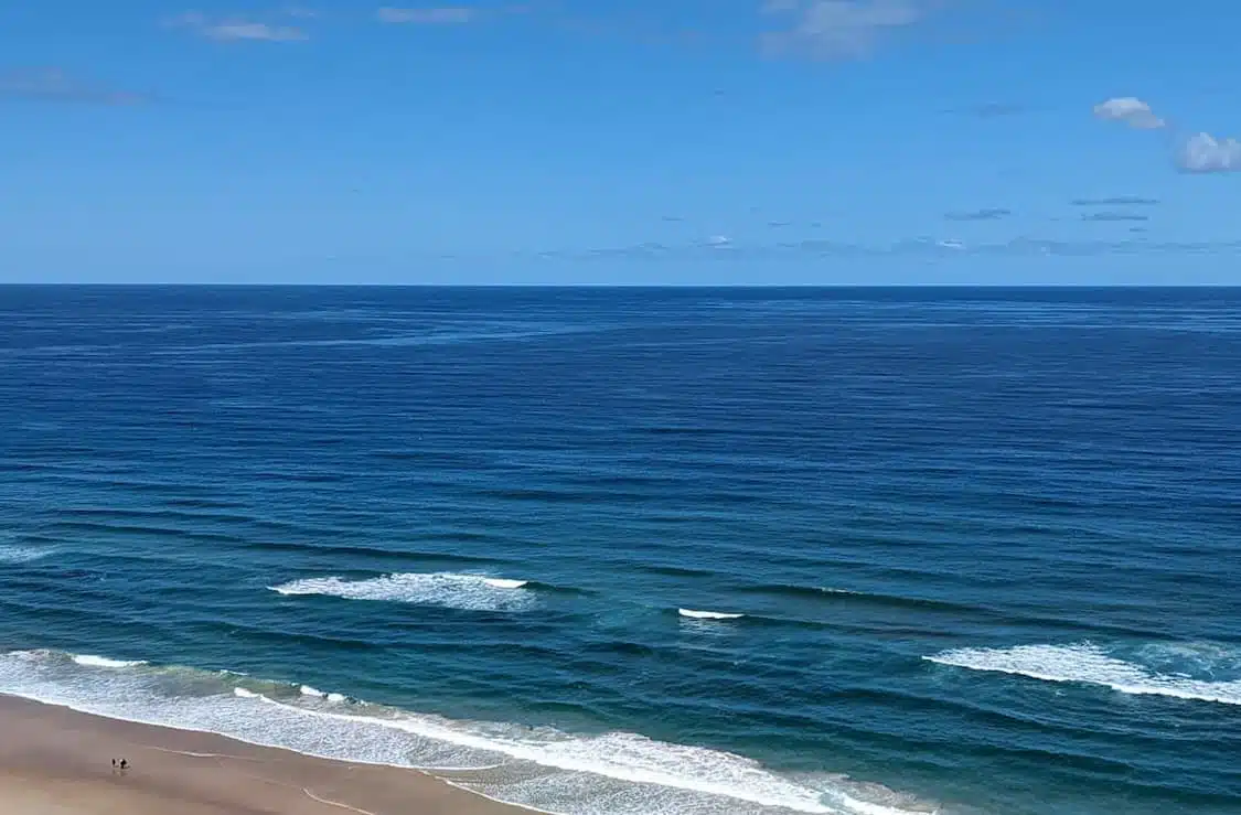 An aerial view of a beach and ocean. Please contact us for more information.